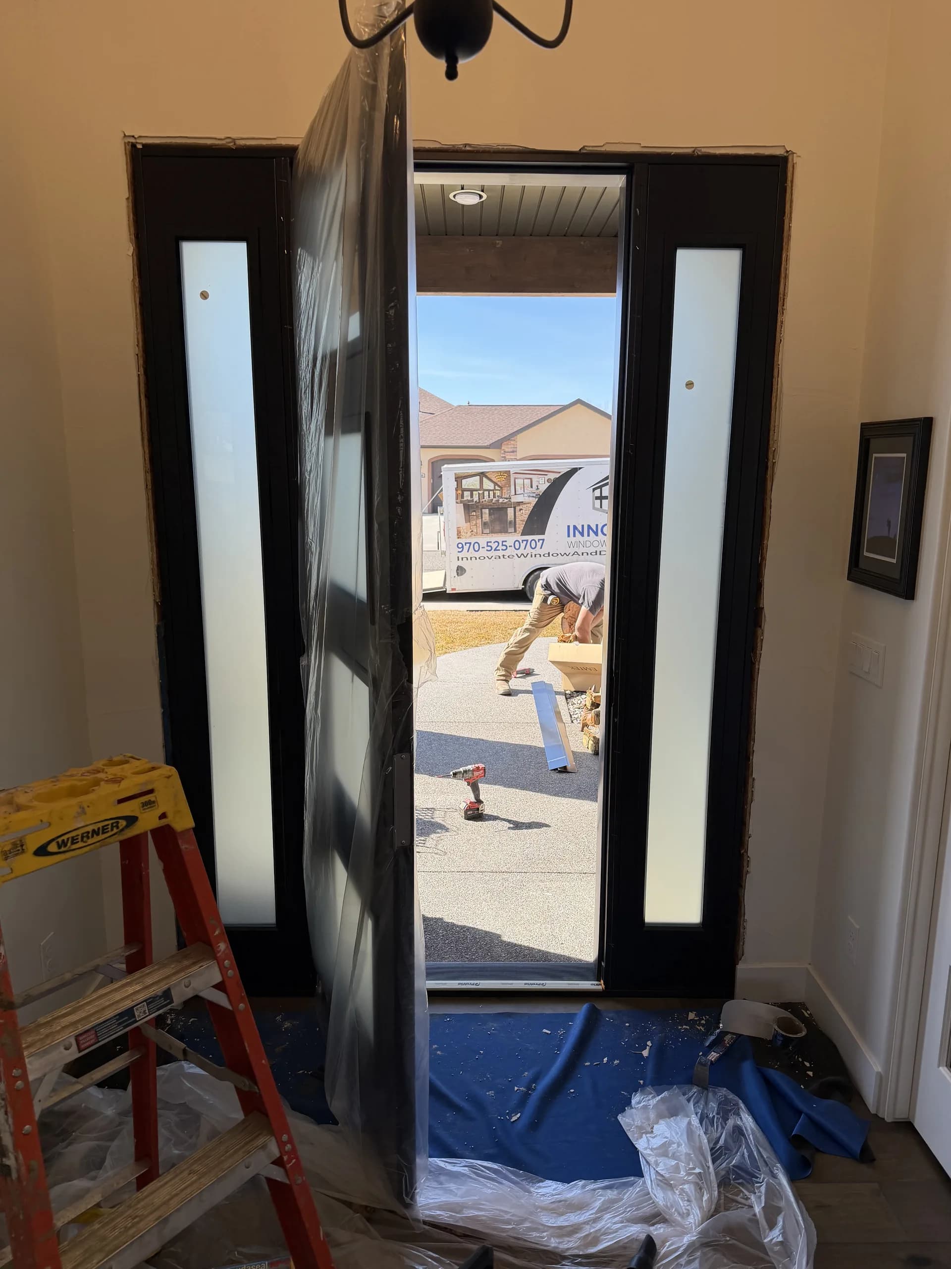 Black-framed glass sliding patio door opening to a mountain view in Western Colorado