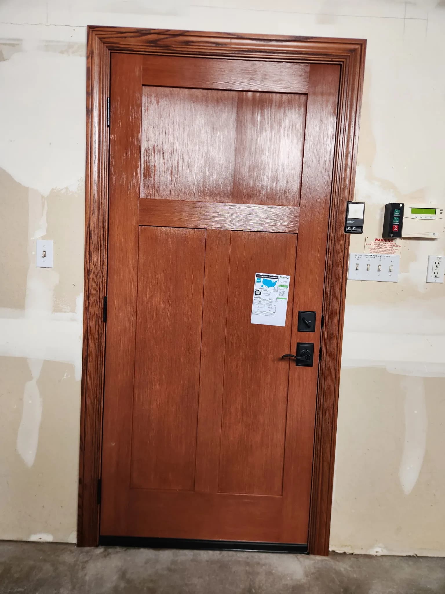 Interior craftsman wood door with smart lock hardware, showing commercial-grade door hardware installation