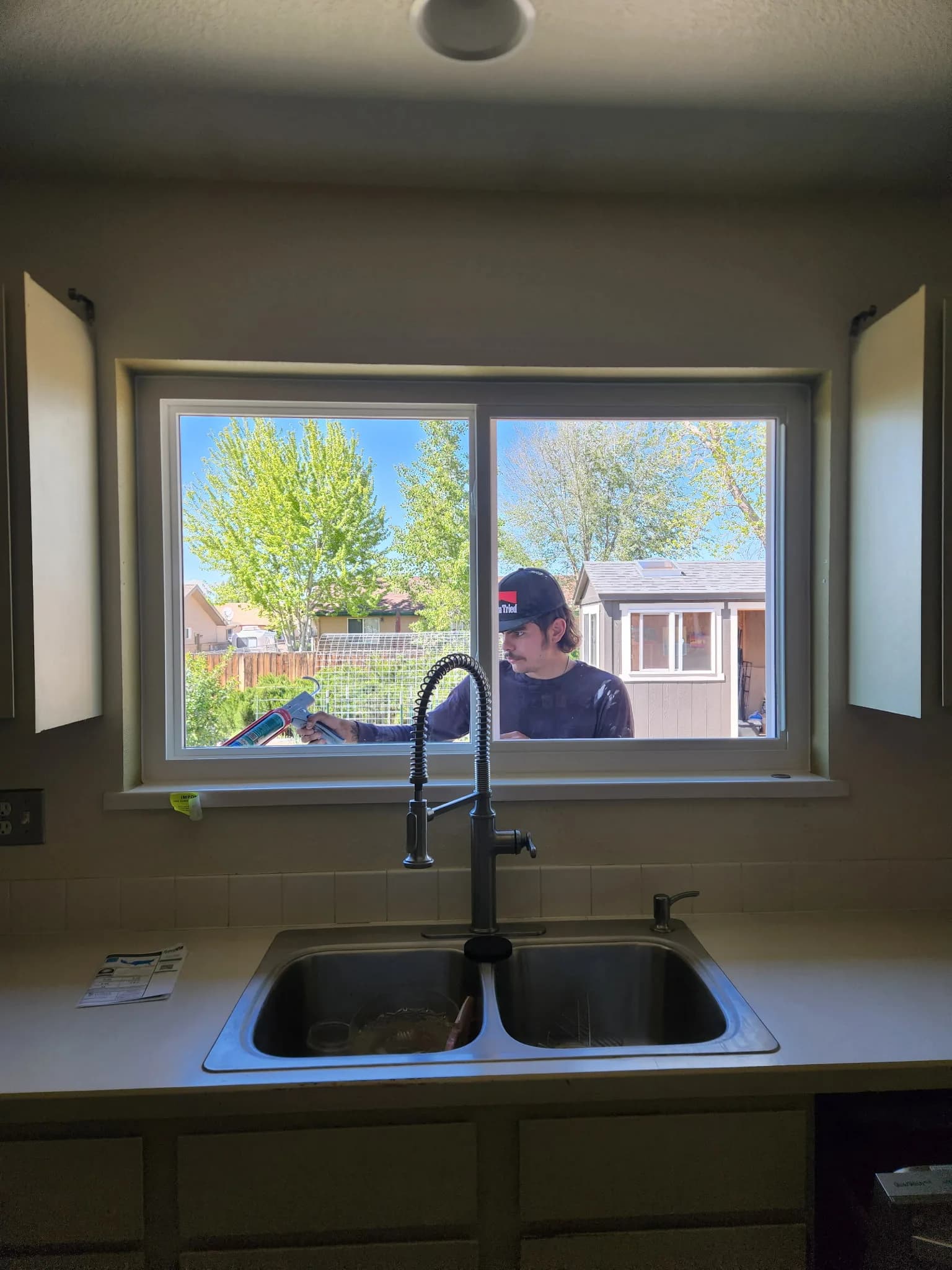 Kitchen window above a sink looking out onto the outdoors