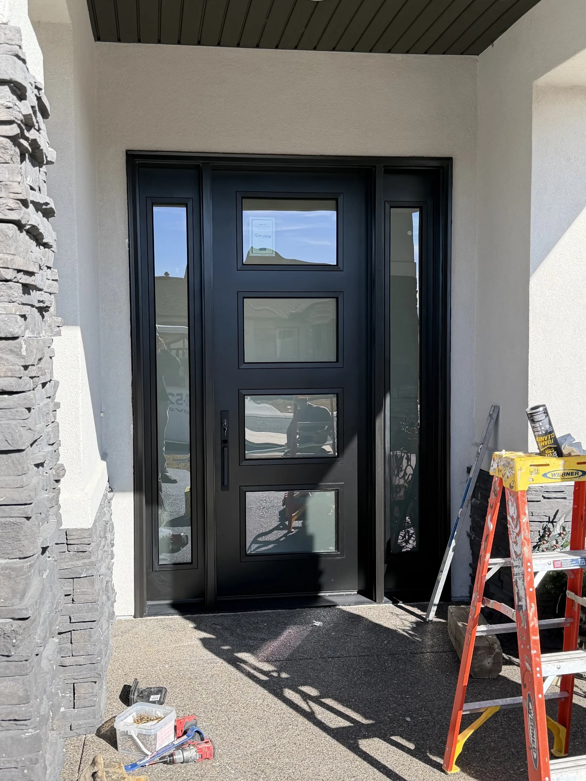 Modern black fire-rated commercial door with frosted glass panel