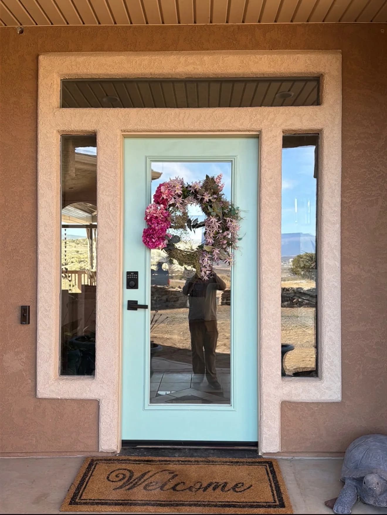Aging entry door on a stucco home before replacement