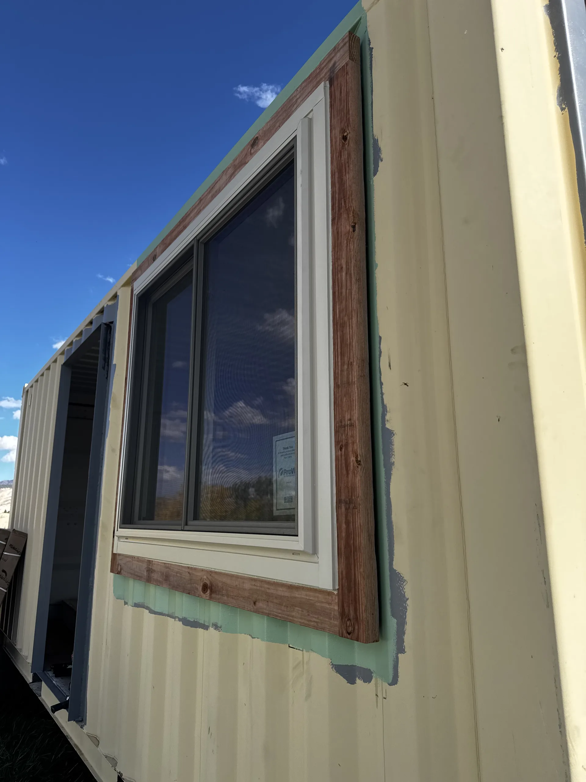 Slider window in a commercial metal building before replacement