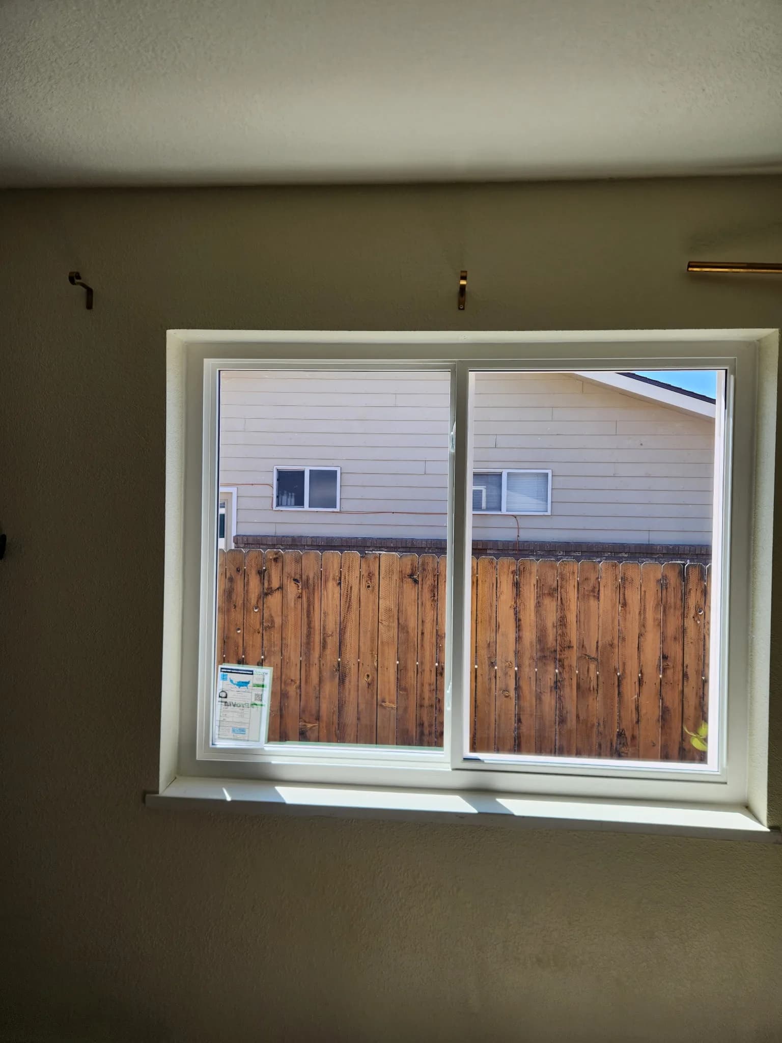 Vinyl double-hung window with a view of a Western Colorado neighborhood