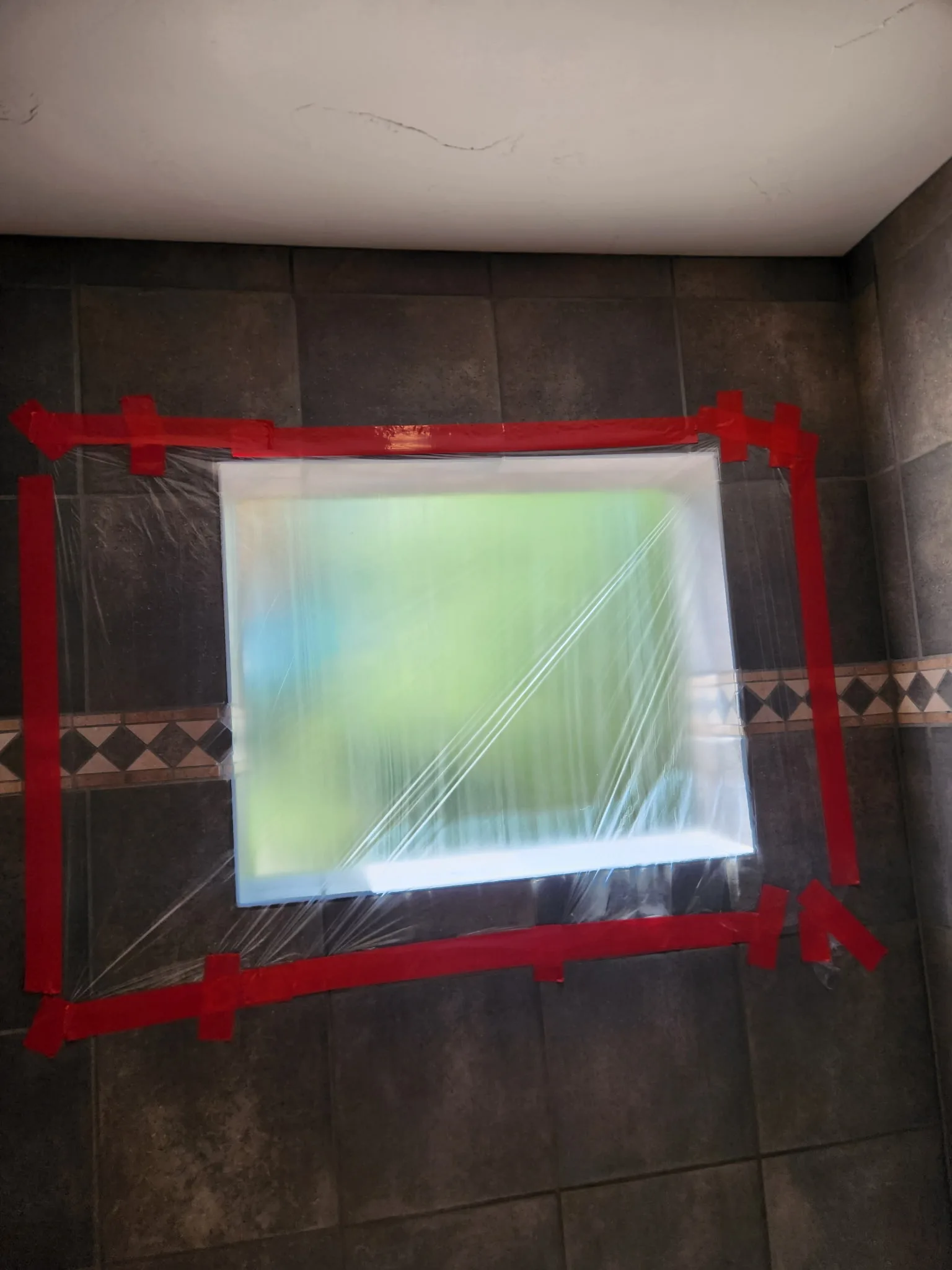 Window opening prepped and masked for replacement installation
