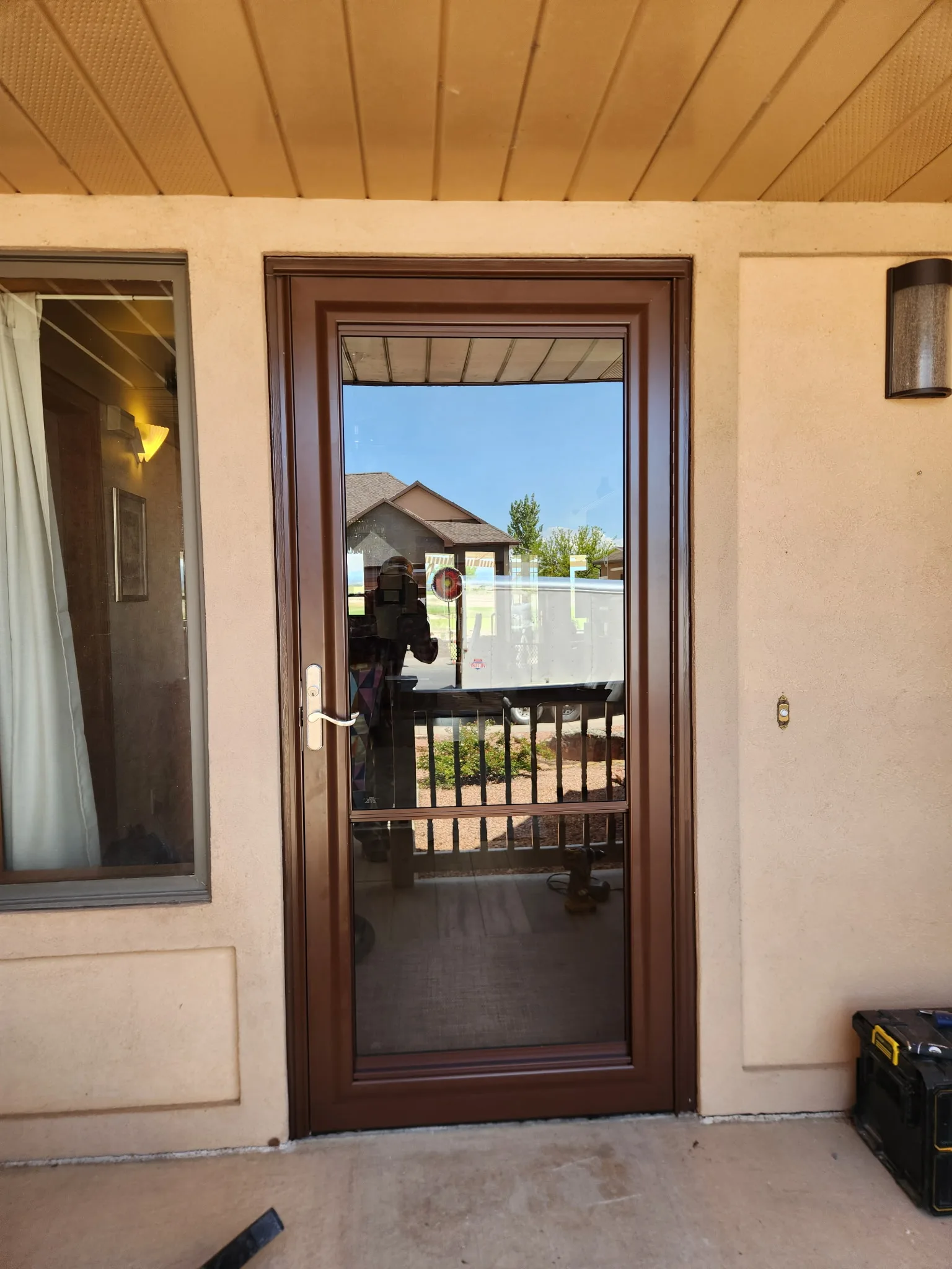 Solid wood entry door on a covered deck in a Western Colorado mountain home